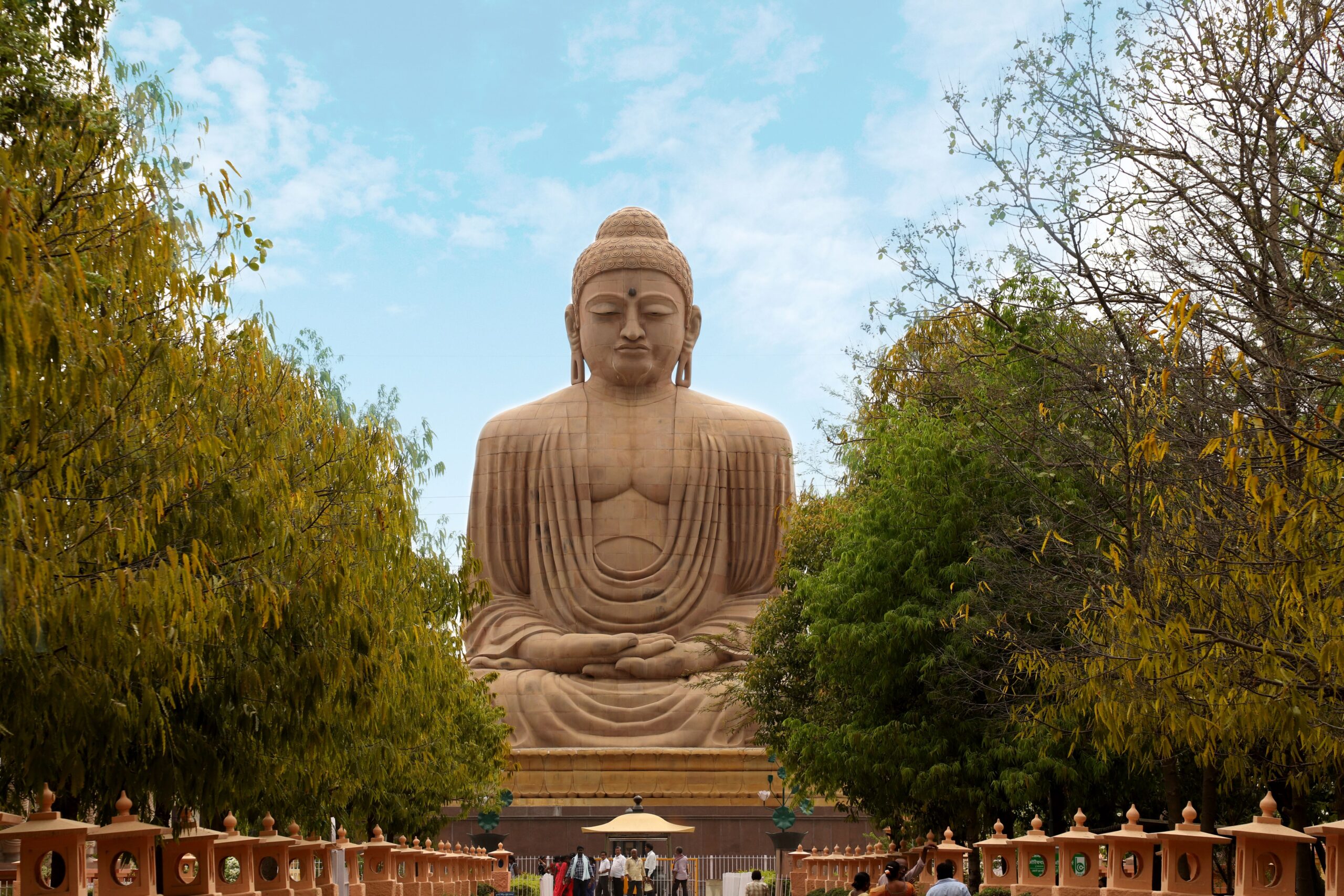 Individuals & Families An awe-inspiring view of the Great Buddha Statue in Bodh Gaya, surrounded by lush greenery.